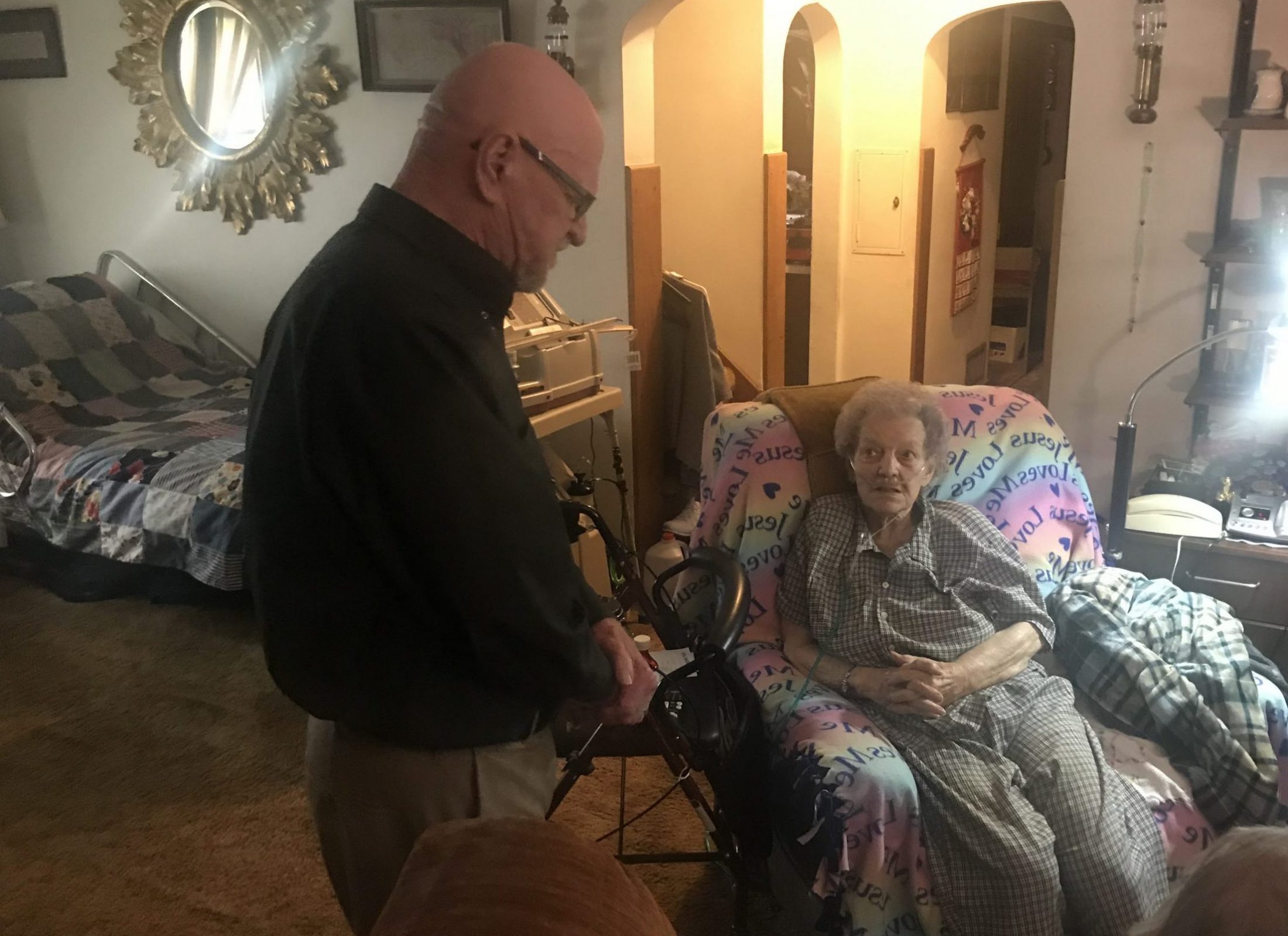 praying with woman in wheelchair